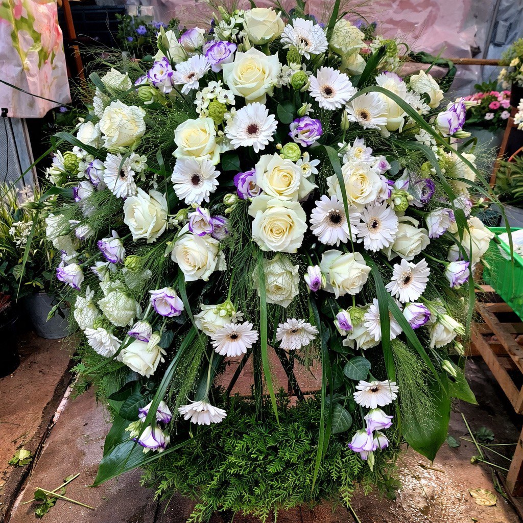 Blumenschmuck bei einer Urnenbeisetzung auf dem Friedhof